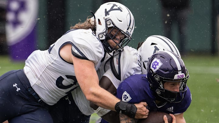 Yale college football players make a tackle