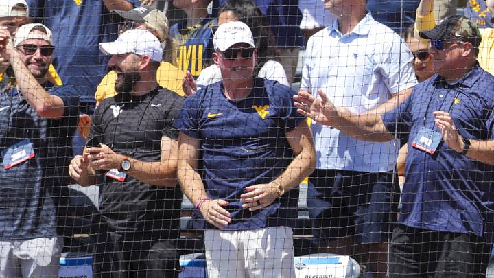 Jun 5, 2026; Morgantown, WV, USA; ESPN commentator Pat McAfee cheers with West Virginia Mountaineers head football coach Rich Rodriguez during the first inning against the Cal Poly Mustangs at Kendrick Family Ballpark. Mandatory Credit: Ben Queen-Imagn Images Jun 5, 2026; Morgantown, WV, USA; ESPN commentator Pat McAfee cheers with West Virginia Mountaineers head football coach Rich Rodriguez during the first inning against the Cal Poly Mustangs at Kendrick Family Ballpark. Mandatory Credit: Ben Queen-Imagn Images