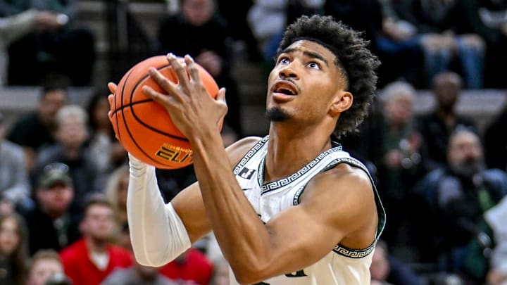 Michigan State's Jaden Akins, right, scores after Florida Atlantic's Niccolo Moretti fell to the floor during the first half on Saturday, Dec. 21, 2024, in East Lansing.