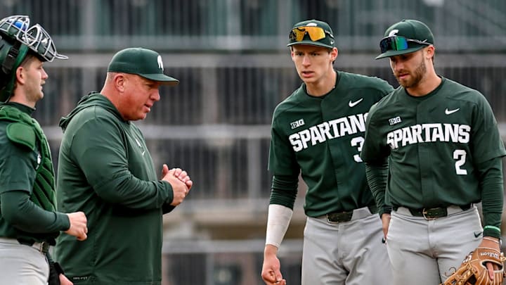 Michigan State's head coach Jake Boss Jr., center, talks to the team during a pitching change in the second inning on Wednesday, April 3, 2024, during the Crosstown Showdown against the Lugnuts at Jackson Field in Lansing.