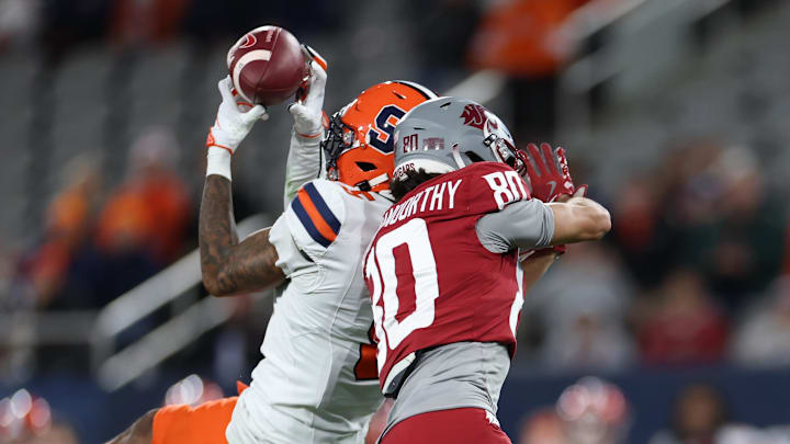 Syracuse Orange defensive back Alijah Clark intercepts the ball against the Washington State Cougars Syracuse Orange defensive back Alijah Clark intercepts the ball against the Washington State Cougars