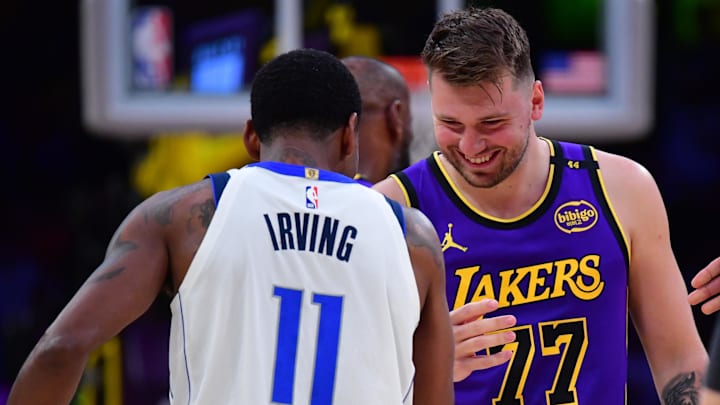 Feb 25, 2025; Los Angeles, California, USA; Los Angeles Lakers guard Luka Doncic (77) reacts with Dallas Mavericks guard Kyrie Irving (11) during the first quarter at Crypto.com Arena. Mandatory Credit: Gary A. Vasquez-Imagn Images
