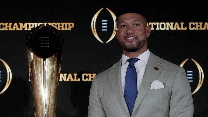 Jan 19, 2025; Atlanta, GA, USA; Ohio State Buckeyes head coach Ryan Day (left) and Notre Dame Fighting Irish head coach Marcus Freeman pose with the College Football Playoff National Championship trophy at press conference at The Westin Peachtree Plaza, Savannah Ballroom. Jan 19, 2025; Atlanta, GA, USA; Ohio State Buckeyes head coach Ryan Day (left) and Notre Dame Fighting Irish head coach Marcus Freeman pose with the College Football Playoff National Championship trophy at press conference at The Westin Peachtree Plaza, Savannah Ballroom.