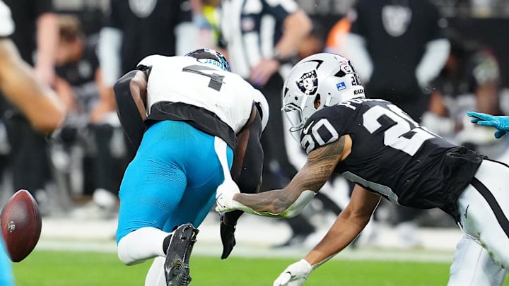 Dec 22, 2024; Paradise, Nevada, USA; Las Vegas Raiders safety Isaiah Pola-Mao (20) causes Jacksonville Jaguars running back Tank Bigsby (4) to fumble during the second quarter at Allegiant Stadium. Mandatory Credit: Stephen R. Sylvanie-Imagn Images
