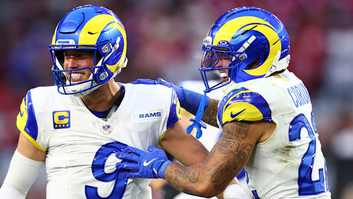 Dec 7, 2025; Glendale, Arizona, USA; Los Angeles Rams quarterback Matthew Stafford (9) reacts with running back Blake Corum (22) against the Arizona Cardinals during the second half at State Farm Stadium. Mandatory Credit: Mark J. Rebilas-Imagn Images Dec 7, 2025; Glendale, Arizona, USA; Los Angeles Rams quarterback Matthew Stafford (9) reacts with running back Blake Corum (22) against the Arizona Cardinals during the second half at State Farm Stadium. Mandatory Credit: Mark J. Rebilas-Imagn Images