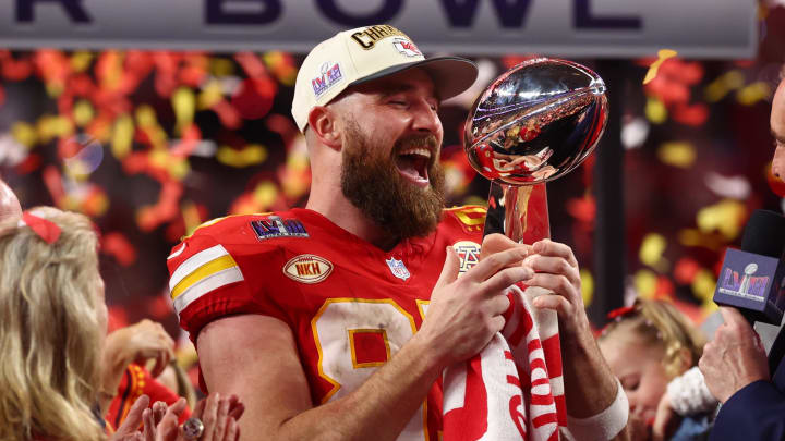Feb 11, 2024; Paradise, Nevada, USA; Kansas City Chiefs tight end Travis Kelce (87) celebrates with the Vince Lombardi Trophy after defeating the San Francisco 49ers in Super Bowl LVIII at Allegiant Stadium. Mandatory Credit: Mark J. Rebilas-USA TODAY Sports