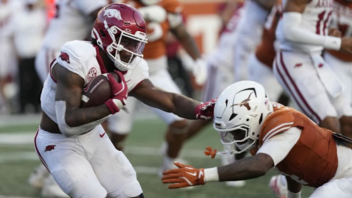 Arkansas Razorbacks quarterback KJ Jackson (7) runs from the pocket while defended by Texas Longhorns defensive back Jelani McDonald (4) during the second half at Darrell K Royal-Texas Memorial Stadium. Arkansas Razorbacks quarterback KJ Jackson (7) runs from the pocket while defended by Texas Longhorns defensive back Jelani McDonald (4) during the second half at Darrell K Royal-Texas Memorial Stadium.