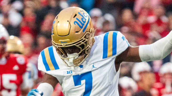 Nov 2, 2024; Lincoln, Nebraska, USA; Nebraska Cornhuskers wide receiver Isaiah Neyor (18) runs after a catch against UCLA Bruins defensive back Bryan Addison (4) and defensive back K.J. Wallace (7) during the fourth quarter at Memorial Stadium. Mandatory Credit: Dylan Widger-Imagn Images