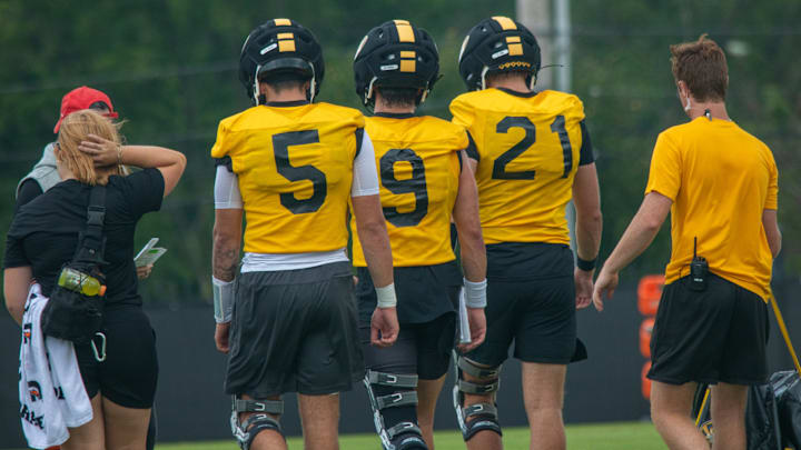 Aug 6, 2025; Columbia, MO, USA; Missouri Tigers quarterbacks Matt Zollers (5), Beau Pribula (9) and Sam Horn (21) walk back during a drill during fall camp at Mizzou Athletic Training Complex.