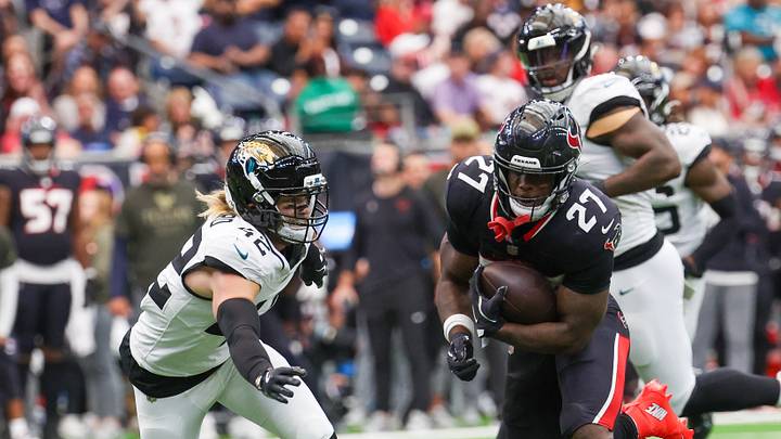 Houston Texans running back Woody Marks (27) rushes against Jacksonville Jaguars safety Andrew Wingard (42) 