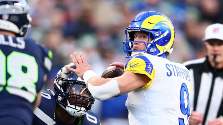 Jan 25, 2026; Seattle, WA, USA; Los Angeles Rams quarterback Matthew Stafford (9) passes against Seattle Seahawks defensive end DeMarcus Lawrence (0) during the first half in the 2026 NFC Championship Game at Lumen Field. Mandatory Credit: Kevin Ng-Imagn Images