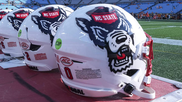 Sep 7, 2024; Charlotte, North Carolina, USA; North Carolina State Wolfpack helmets during pregame activity for the Dukes Mayo Classic against the Tennessee Volunteers at Bank of America Stadium. Mandatory Credit: Jim Dedmon-Imagn Images
