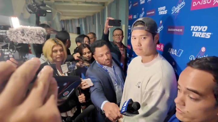 Shohei Ohtani in a media scrum after the Los Angeles Dodgers beat the Atlanta Braves on April 2, 2025.