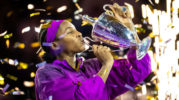 Coco Gauff kisses the WTA Finals trophy.