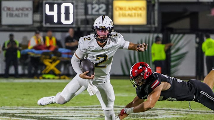 Aug 28, 2025; Orlando, Florida, USA; UCF Knights quarterback Tayven Jackson (2) avoids a tackle during the second quarter against the Jacksonville State Gamecocks at Acrisure Bounce House. Mandatory Credit: Mike Watters-Imagn Images