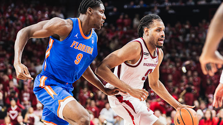 Arkansas' Jonas Aidoo (9) drives on Florida's Rueben Chinyelu (9). The Gators won 71-53.