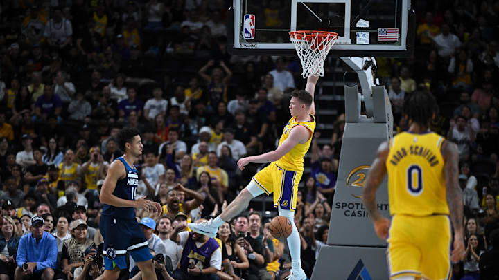Oct 4, 2024; Palm Desert, California, USA; Los Angeles Lakers guard Dalton Knecht (4) hangs on the rim after dunking against Minnesota Timberwolves center Jesse Edwards (14) during the second half at Acrisure Arena. Mandatory Credit: Jonathan Hui-Imagn Images Oct 4, 2024; Palm Desert, California, USA; Los Angeles Lakers guard Dalton Knecht (4) hangs on the rim after dunking against Minnesota Timberwolves center Jesse Edwards (14) during the second half at Acrisure Arena. Mandatory Credit: Jonathan Hui-Imagn Images