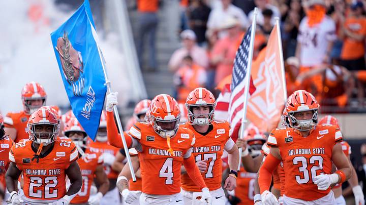 Oklahoma State runs on to the field. Oklahoma State runs on to the field.