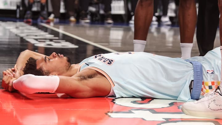 Dec 27, 2024; Brooklyn, New York, USA;  San Antonio Spurs center Victor Wembanyama (1) lays on the court after getting fouled in the third quarter against the Brooklyn Nets at Barclays Center. Mandatory Credit: Wendell Cruz-Imagn Images