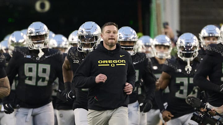 Nov 30, 2024; Eugene, Oregon, USA; Oregon Ducks head coach Dan Lanning runs out with the team before a game against the Washington Huskies at Autzen Stadium. 