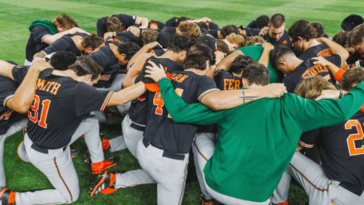 The Miami Hurricanes Baseball team praying after a tough loss against the UCF Knights in Orlando, Fla. The Miami Hurricanes Baseball team praying after a tough loss against the UCF Knights in Orlando, Fla.