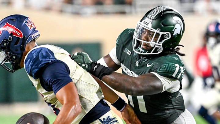 Michigan State's Ken Talley, right, tackles Florida Atlantic's Cam Fancher for a loss on fourth down during the fourth quarter at Spartan Stadium in East Lansing.