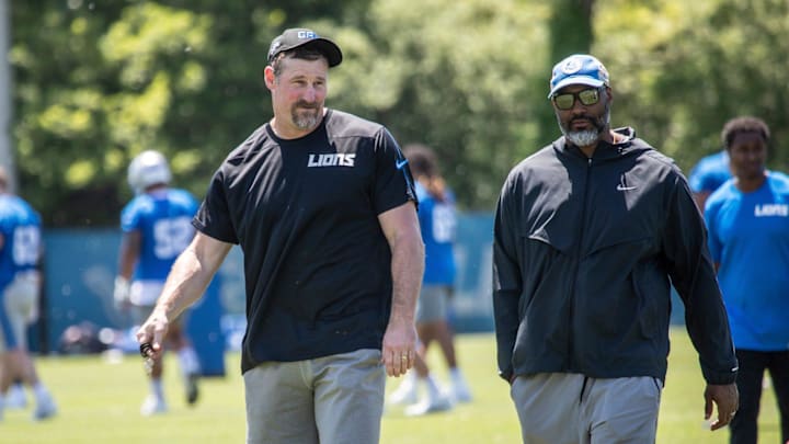 Lions head coach Dan Campbell walks off the field with general manager Brad Holmes 