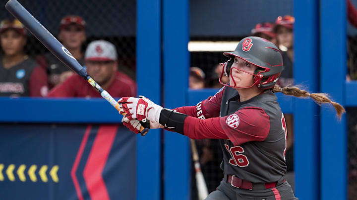 Oklahoma Sooners outfielder Abby Dayton (16) hits a long fly ball for an out in the third inning against the Texas Tech Red Raiders during the NCAA Softball Women's College World Series semifinal game at Devon Park. 