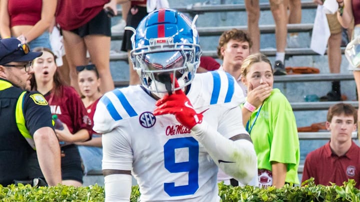 Oct 5, 2024; Columbia, South Carolina, USA; Mississippi Rebels wide receiver Tre Harris (9) celebrates knocking a pass away from South Carolina Gamecocks wide receiver Dalevon Campbell (15), in the hedge, in the second half at Williams-Brice Stadium. Mandatory Credit: Jeff Blake-Imagn Images