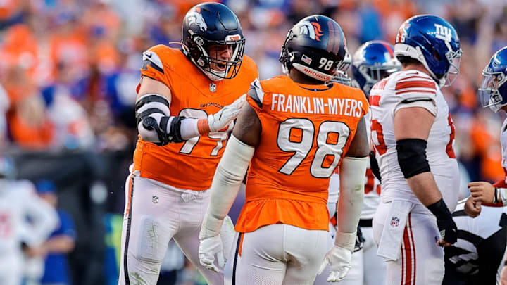 Oct 19, 2025; Denver, Colorado, USA; Denver Broncos defensive end Zach Allen (99) celebrates his sack with defensive end John Franklin-Myers (98) in the fourth quarter against the New York Giants at Empower Field at Mile High. 
