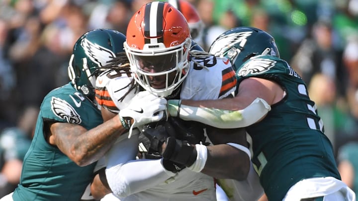Oct 13, 2024; Philadelphia, Pennsylvania, USA; Cleveland Browns tight end David Njoku (85) is tackled by Philadelphia Eagles cornerback Darius Slay Jr. (2) and safety Reed Blankenship (32) during the second quarter at Lincoln Financial Field.