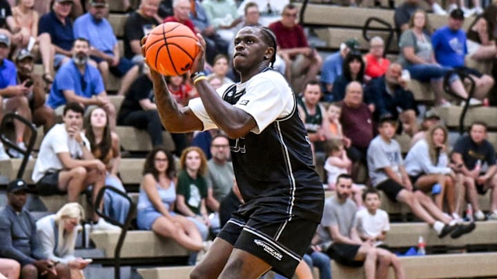 Team Motorcars and Michigan State's Coen Carr makes a 3-pointer against Team Fargo during the Moneyball Pro-Am on Tuesday, June 24, 2025, at Holt High School. Team Motorcars and Michigan State's Coen Carr makes a 3-pointer against Team Fargo during the Moneyball Pro-Am on Tuesday, June 24, 2025, at Holt High School.