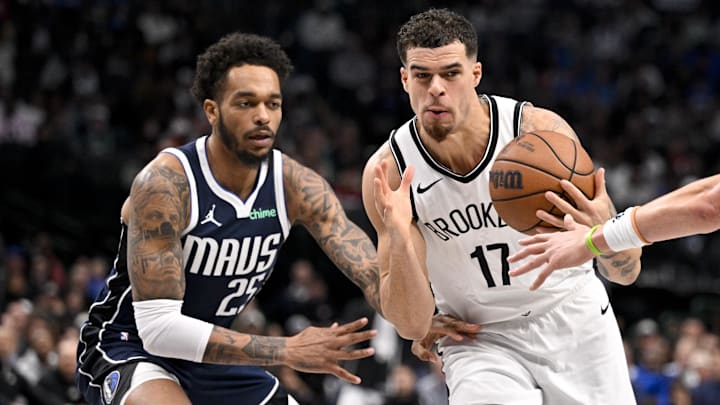 Dec 12, 2025; Dallas, Texas, USA; Brooklyn Nets forward Michael Porter Jr. (17) drives to the basket past Dallas Mavericks forward P.J. Washington (25) during the second half at the American Airlines Center. Mandatory Credit: Jerome Miron-Imagn Images