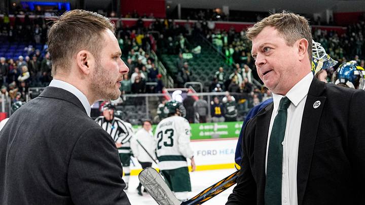 Michigan head coach Brandon Naurato, left, shakes hands with Michigan State head coach Adam Nightingale after 5-2 loss at the Duel in the D at Little Caesars Arena in Detroit on Saturday, February 7, 2026.