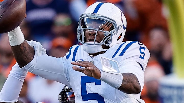 Dec 15, 2024; Denver, Colorado, USA; Indianapolis Colts quarterback Anthony Richardson (5) attempts a pass under pressure from Denver Broncos defensive end John Franklin-Myers (98) in the second quarter at Empower Field at Mile High. Mandatory Credit: Isaiah J. Downing-Imagn Images