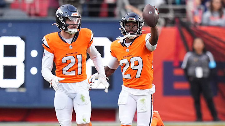 Oct 27, 2024; Denver, Colorado, USA; Denver Broncos cornerback Ja'Quan McMillian (29) celebrates his turnover with cornerback Riley Moss (21) in the second half against the Carolina Panthers at Empower Field at Mile High. 