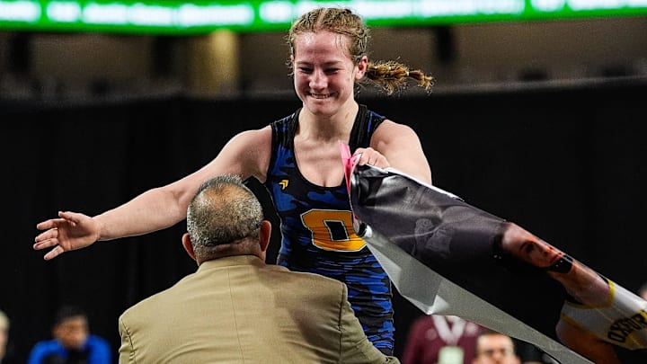 Cheyenne Frank of Oxford, shown hugging her coach after winning the 120-pound Girls MHSAA state title in March, was one of four double champions from Michigan at the Grappler Fall Classic.