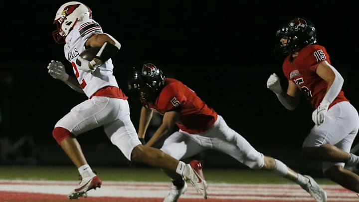 Newton's Isaiah Hansen (2) runs for a touchdown around Gilbert's safety Alden Short (5) during first quarter at Tigers Stadium on Friday, Oct. 18, 2024, in Gilbert, Iowa