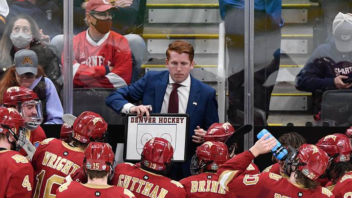 Apr 9, 2022; Boston, MA, USA; Denver Pioneers head coach David Carle talks with his team during a timeout during the third period of the 2022 Frozen Four college ice hockey national championship game against the Minnesota State Mavericks at TD Garden. Mandatory Credit: Brian Fluharty-Imagn Images Apr 9, 2022; Boston, MA, USA; Denver Pioneers head coach David Carle talks with his team during a timeout during the third period of the 2022 Frozen Four college ice hockey national championship game against the Minnesota State Mavericks at TD Garden. Mandatory Credit: Brian Fluharty-Imagn Images