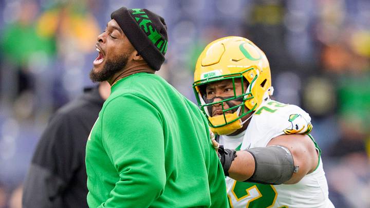 Oregon offensive line coach A'lique Terry, left, works with Oregon offensive lineman Iapani Laloulu during warmups as the Oregon Ducks take on the Washington Huskies on Nov. 29, 2025, at Husky Stadium in Seattle, Washington. Oregon offensive line coach A'lique Terry, left, works with Oregon offensive lineman Iapani Laloulu during warmups as the Oregon Ducks take on the Washington Huskies on Nov. 29, 2025, at Husky Stadium in Seattle, Washington.