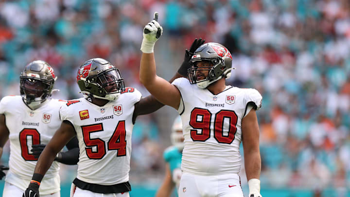 Dec 28, 2025; Miami Gardens, Florida, USA; Tampa Bay Buccaneers defensive end Logan Hall (90) celebrates with linebacker Lavonte David (54) after sacking Miami Dolphins quarterback Quinn Ewers (14, not pictured) during the second quarter at Hard Rock Stadium. Mandatory Credit: Nathan Ray Seebeck-Imagn Images