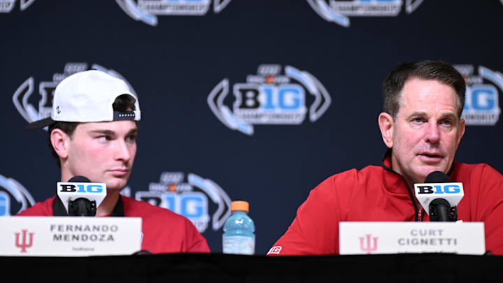 Dec 6, 2025; Indianapolis, IN, USA; Indiana Hoosiers quarterback Fernando Mendoza (15) and head coach Curt Cignetti speak in a press conference after defeating the Ohio State Buckeyes in the 2025 Big Ten championship game at Lucas Oil Stadium. Dec 6, 2025; Indianapolis, IN, USA; Indiana Hoosiers quarterback Fernando Mendoza (15) and head coach Curt Cignetti speak in a press conference after defeating the Ohio State Buckeyes in the 2025 Big Ten championship game at Lucas Oil Stadium.