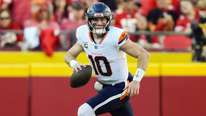 Nov 10, 2024; Kansas City, Missouri, USA; Denver Broncos quarterback Bo Nix (10) rolls out to pass during the second half against the Kansas City Chiefs at GEHA Field at Arrowhead Stadium. 