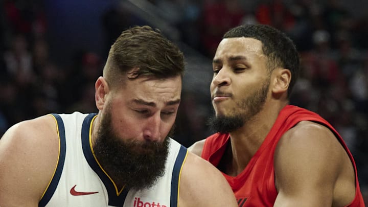 Portland Trail Blazers forward Kris Murray ties up Denver Nuggets center Jonas Valanciunas.