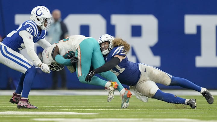Oct 20, 2024; Indianapolis, Indiana, USA;  Indianapolis Colts cornerback Jaylon Jones (40) and Indianapolis Colts linebacker Grant Stuard (41) wrap up Miami Dolphins running back De'Von Achane (28) on Sunday, Oct. 20, 2024, during a game against the Miami Dolphins at Lucas Oil Stadium. Mandatory Credit: Grace Hollars/IndyStar USA TODAY Network via Imagn Images