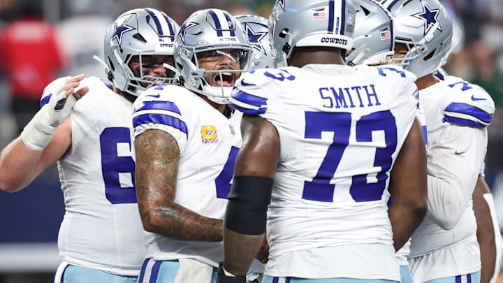 Dallas Cowboys quarterback Dak Prescott (4) celebrates with teammates after scoring a touchdown against the Green Bay Packers in the second quarter at AT&T Stadium. Dallas Cowboys quarterback Dak Prescott (4) celebrates with teammates after scoring a touchdown against the Green Bay Packers in the second quarter at AT&T Stadium.
