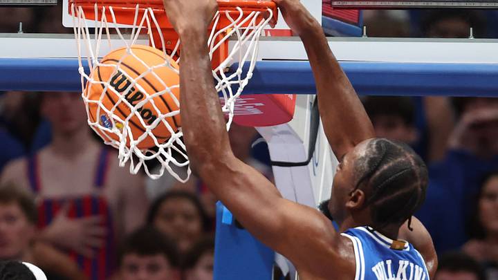 Oct 25, 2026; Lawrence, Kansas, USA;  Duke Blue Devils forward Sebastian Wilkins (5) dunks against Kansas Jayhawks guard Dennis Parker Jr. (11) during the second half at Allen Fieldhouse.  Mandatory Credit: Scott Sewell-Imagn Images