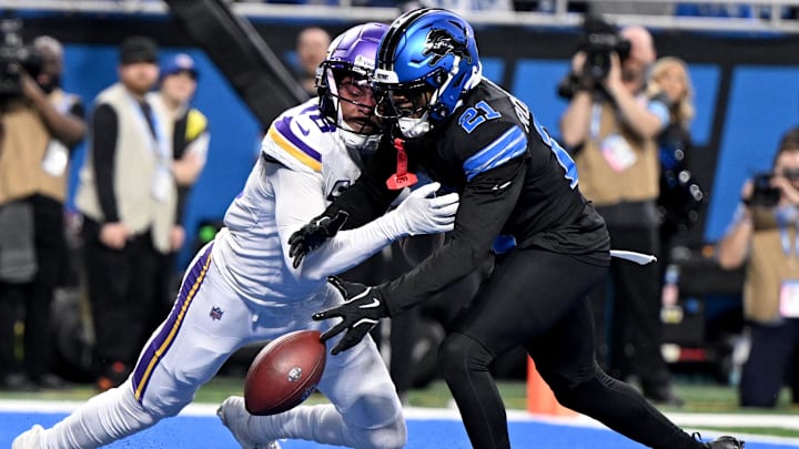 Jan 5, 2025; Detroit, Michigan, USA; Detroit Lions cornerback Amik Robertson (21) breaks up a pass in the end zone intended for Minnesota Vikings wide receiver Justin Jefferson (18) in the second quarter at Ford Field. Mandatory Credit: Lon Horwedel-Imagn Images