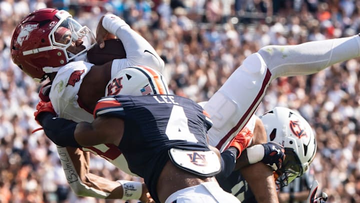 Arkansas Razorbacks quarterback Taylen Green (10) dives at the goal line and is stopped by Auburn Tigers safety Sylvester Smith (19) and defensive back Kayin Lee (4) at Jordan-Hare Stadium in Auburn, Ala.