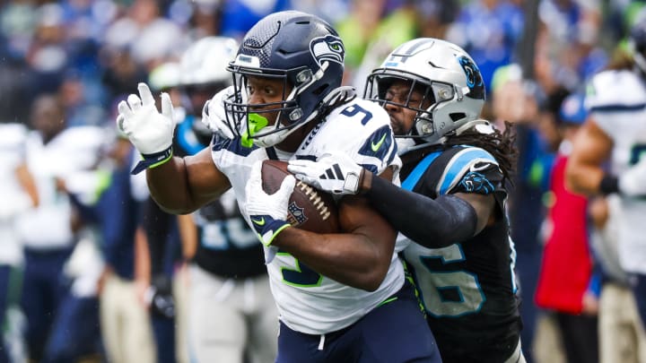 Sep 24, 2023; Seattle, Washington, USA; Carolina Panthers cornerback Donte Jackson (26) tackles Seattle Seahawks running back Kenneth Walker III (9) following a reception during the third quarter at Lumen Field. Mandatory Credit: Joe Nicholson-USA TODAY Sports